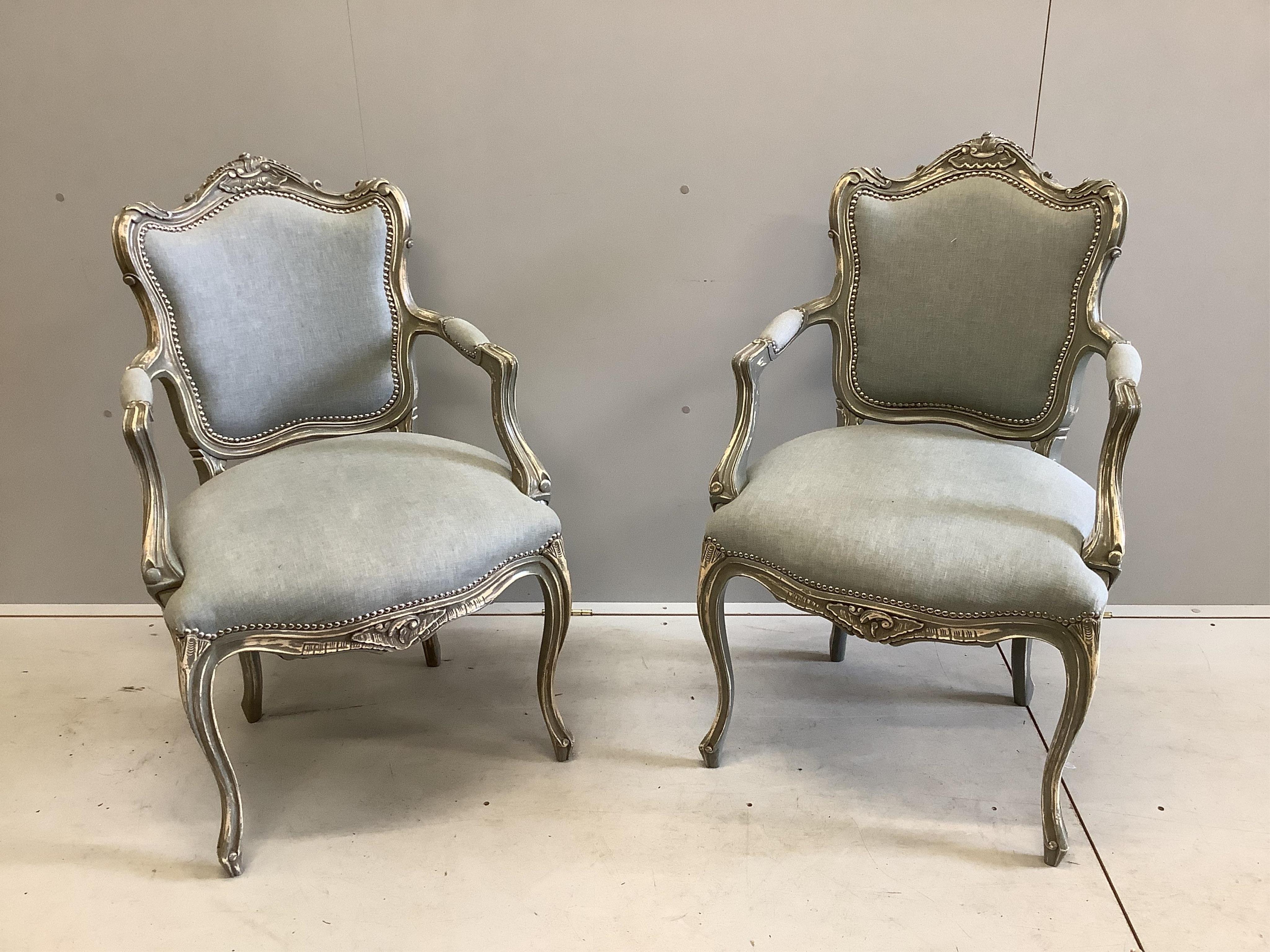 A pair of Louis XV style painted framed fauteuils, width 58cm, depth 54cm, height 99cm. Condition - good